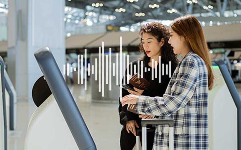 women with a voice-enabled kiosk