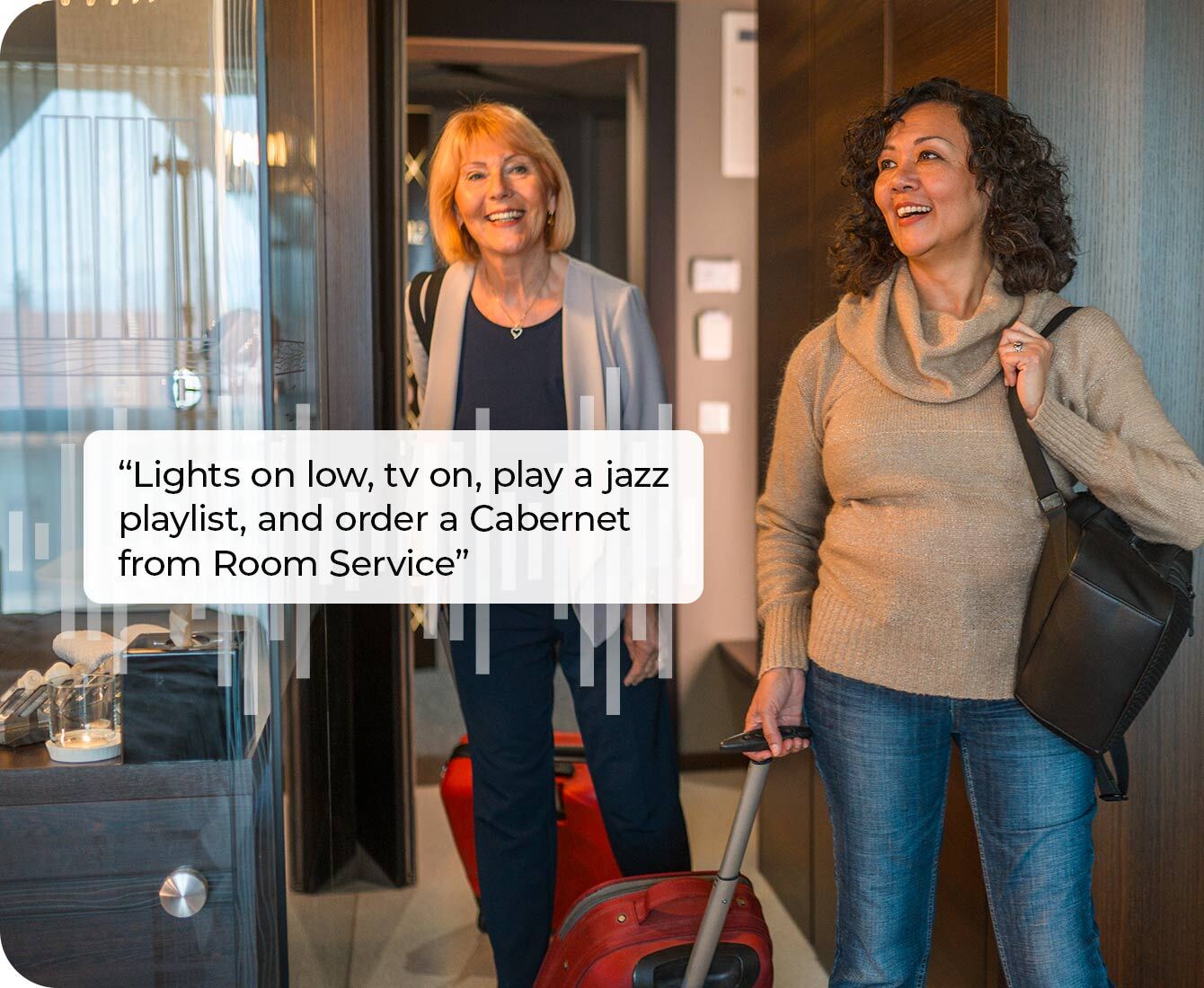 two women interacting with a voice-enabled hotel room