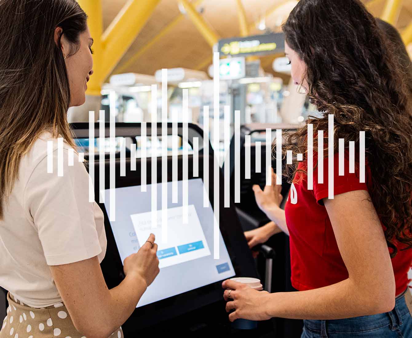 two women using a voice assisted kiosk